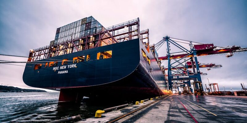 A large cargo ship docked at Gothenburg port with industrial cranes, Sweden.