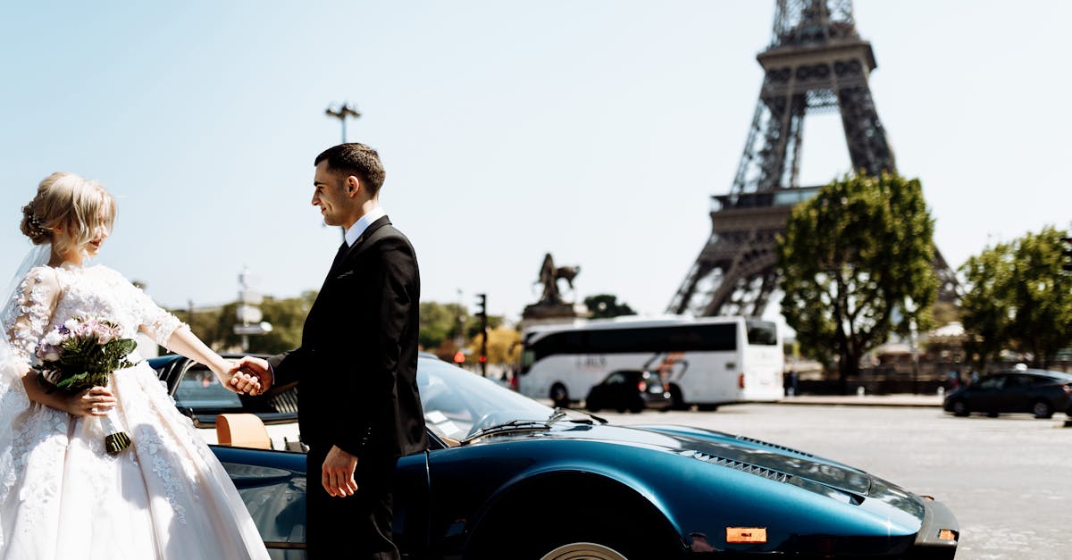 A romantic couple's wedding day captured near the Eiffel Tower in Paris with a luxury car in the foreground.